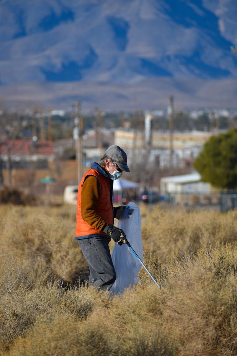 Field researcher in high-visibility clothing and a respirator taking outdoor measurements